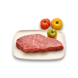 Freshly butchered marbled beef steak on white plate with heirloom tomatoes, showcasing premium grass-fed quality