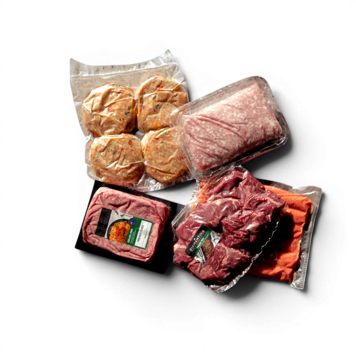 Assorted grass-fed beef products including patties, mince, and steaks in vacuum-sealed packs