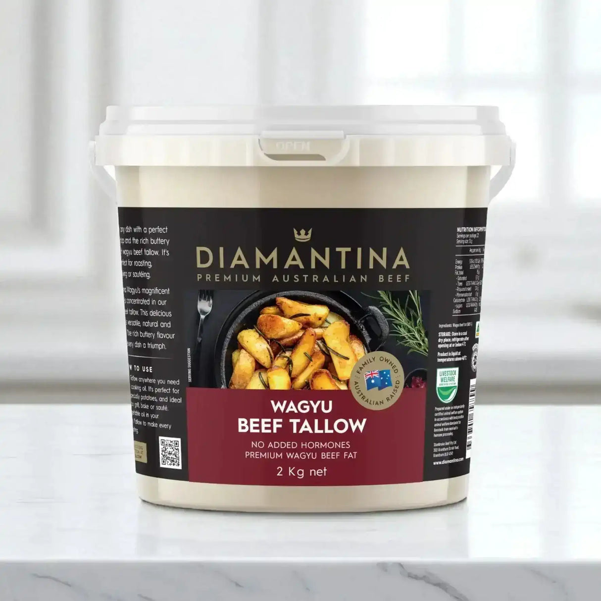2kg bucket of Diamantina Wagyu beef tallow on a marble countertop, kitchen background