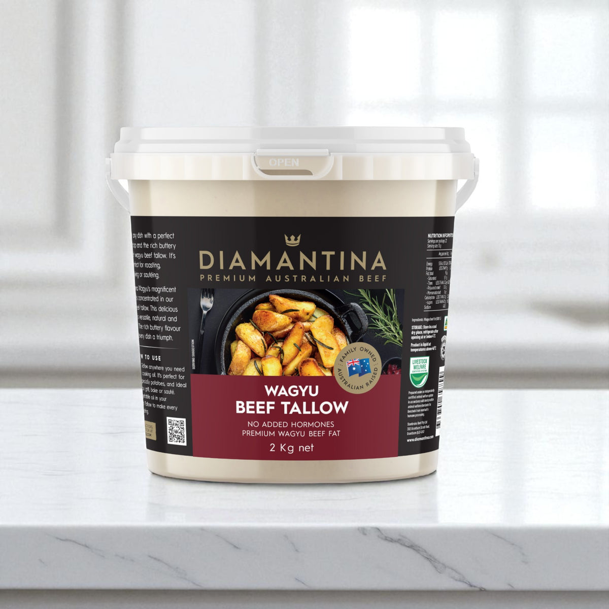 2kg bucket of Diamantina Wagyu beef tallow on a marble countertop, kitchen background