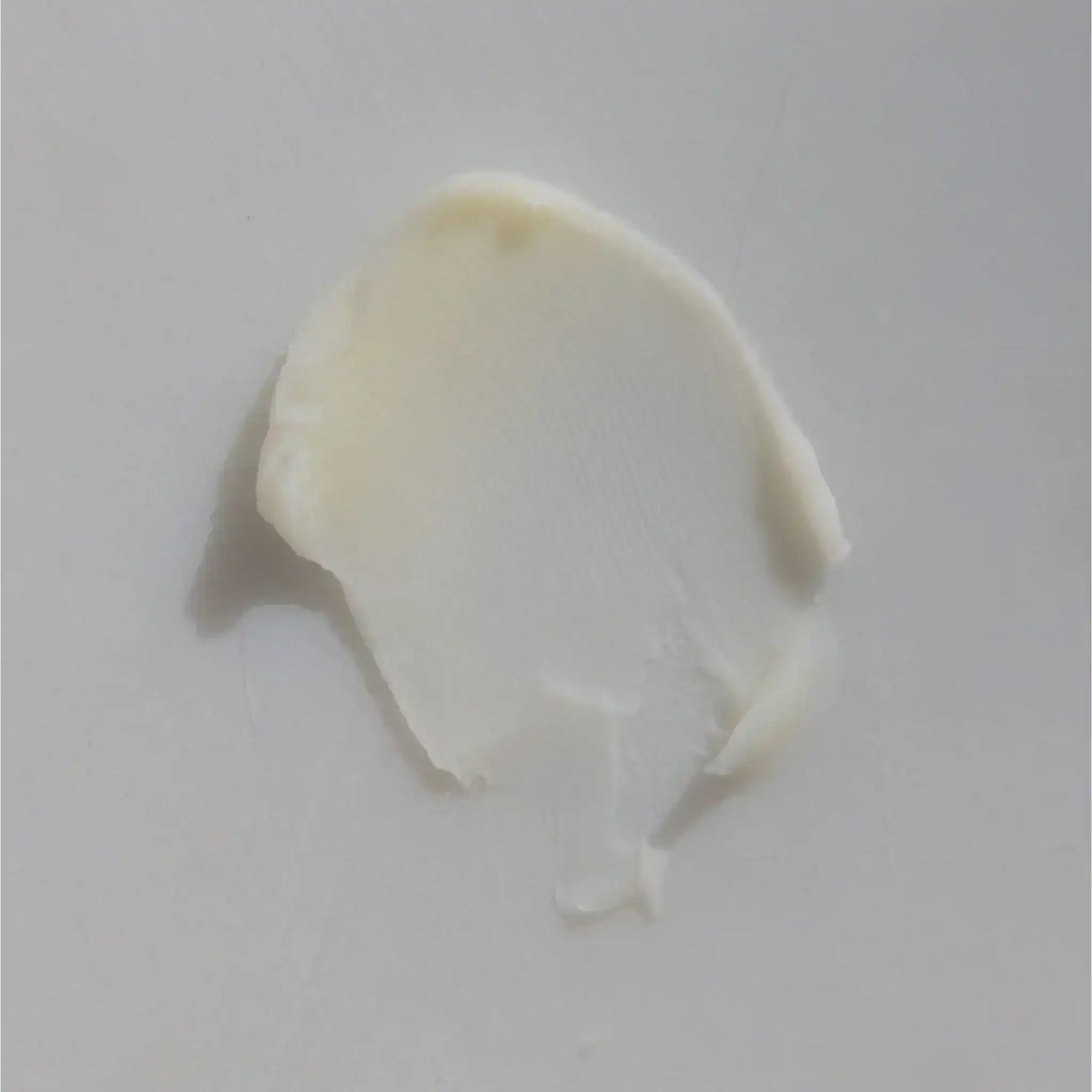 Smooth smear of creamy wagyu beef tallow on a white background