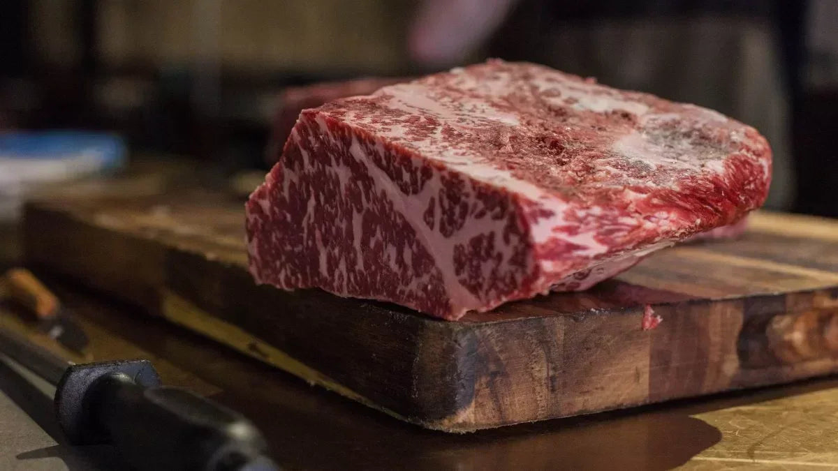 Premium marbled Wagyu beef cut on wooden board from Peter Augustus Craft Butcher