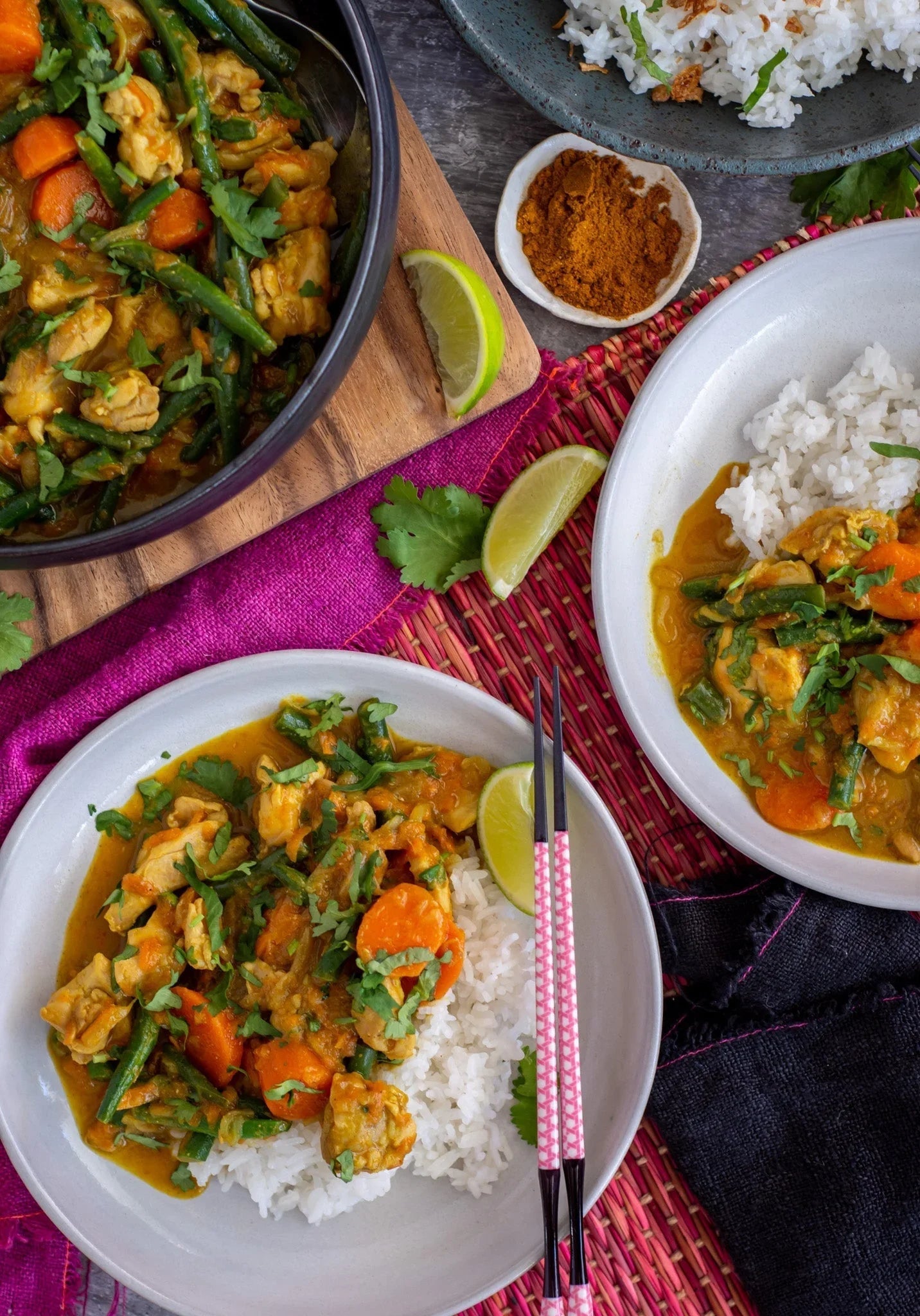 Australian beef curry with green beans, carrots, and rice, garnished with fresh cilantro and lime