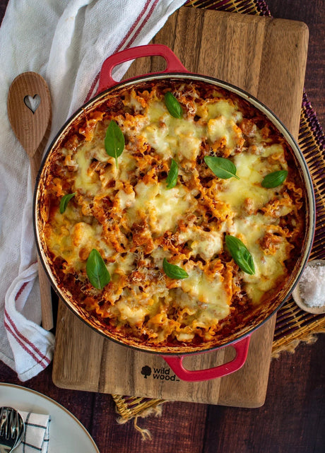 Baked beef lasagna with melted cheese and basil in red dish, showcasing premium Australian beef