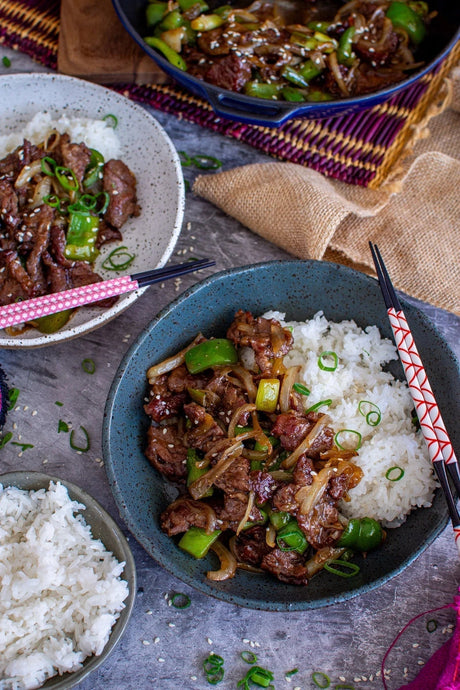 Australian beef stir-fry with green capsicum, onions, and rice in ceramic bowls, Peter Augustus