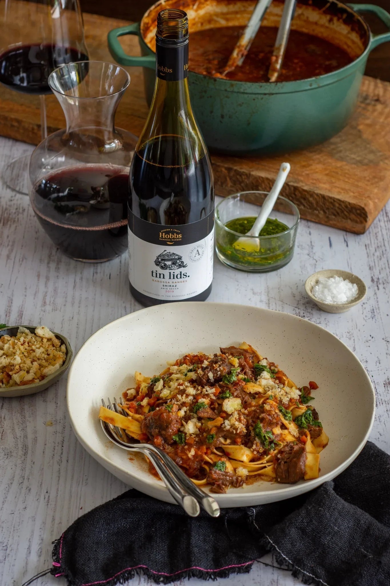Australian beef ragu pasta topped with herbs and breadcrumbs, paired with red wine and gourmet sauce