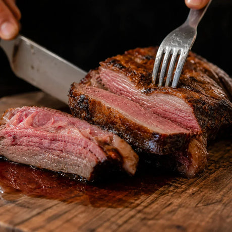Juicy sliced Australian beef brisket from Peter Augustus Craft Butcher on a wooden board