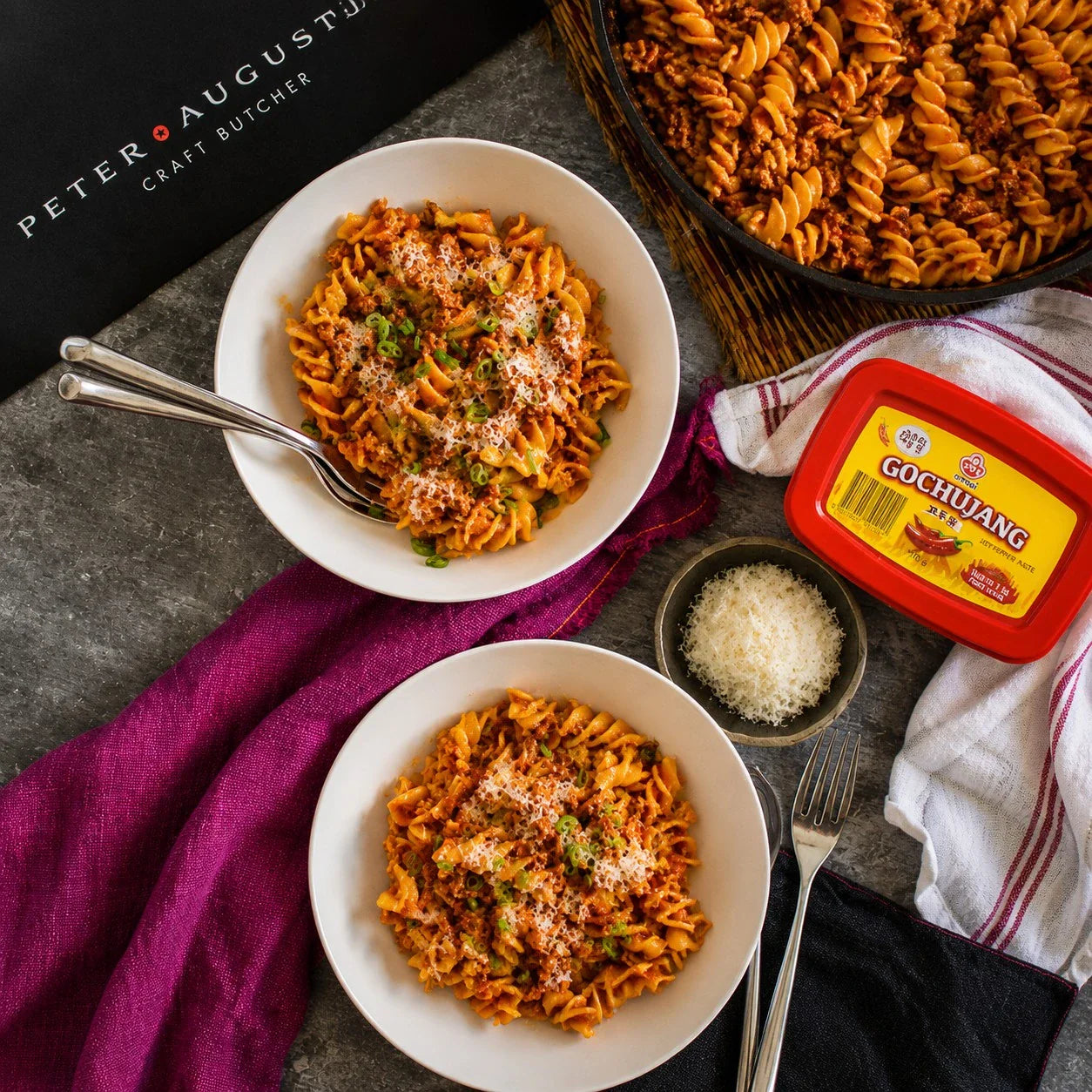 Peter Augustus gourmet beef pasta with cheese and gochujang, served in white bowls