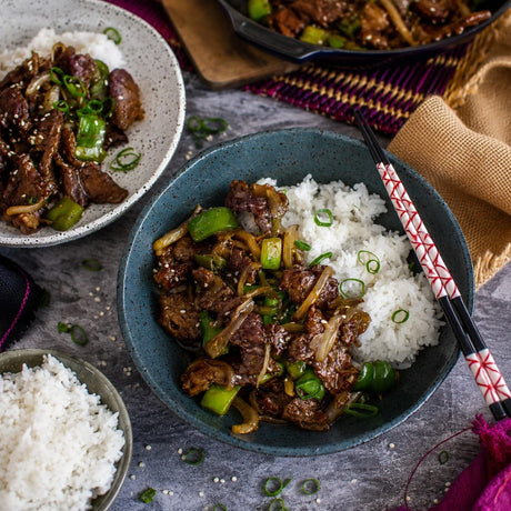 Australian beef stir-fry with green capsicum, onions, and rice in ceramic bowls, Peter Augustus