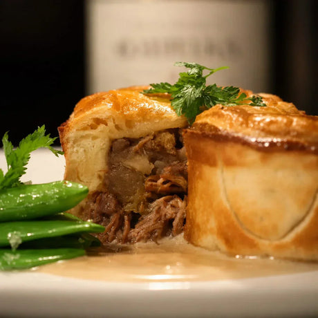 Gourmet beef pie with golden pastry, tender beef filling, and fresh snap peas, Peter Augustus