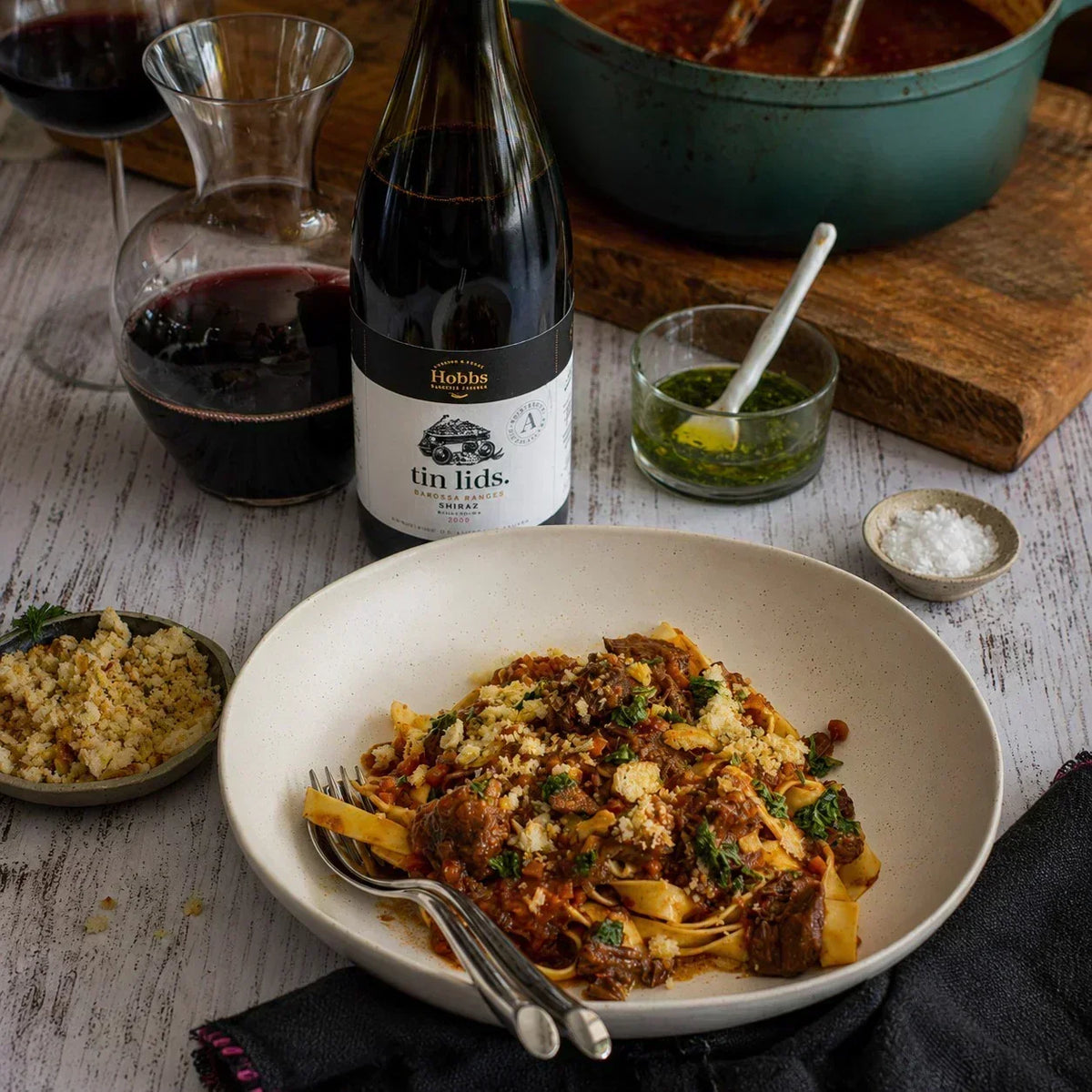 Australian beef ragu pasta topped with herbs and breadcrumbs, paired with red wine and gourmet sauce