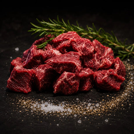 Premium Australian chuck steak cubes with marbling, garnished with fresh rosemary and spices