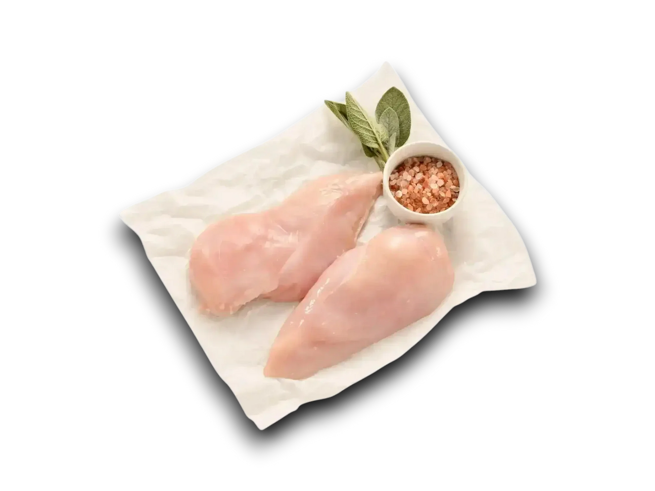 Free range skinless chicken breast fillets on baking paper with pink rock salt and sage