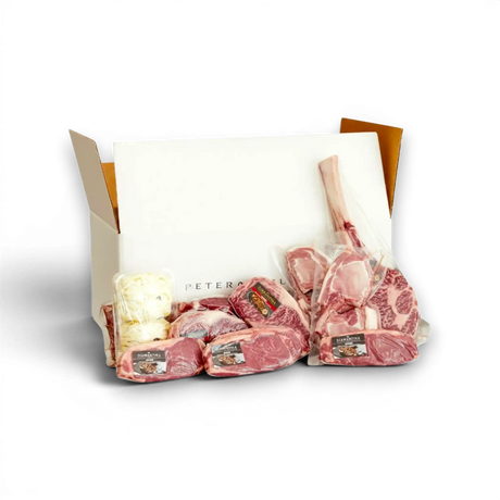 Premium Wagyu and Pure Angus beef cuts in a delivery box, vacuum-sealed and ready for gourmet cooking.