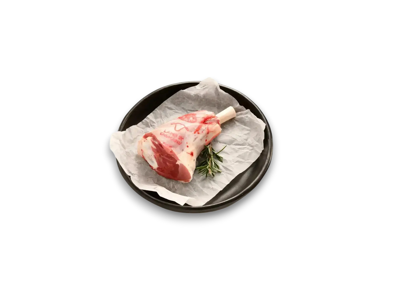 Raw lamb shank with rosemary on parchment in a black dish, Peter Augustus Craft Butcher