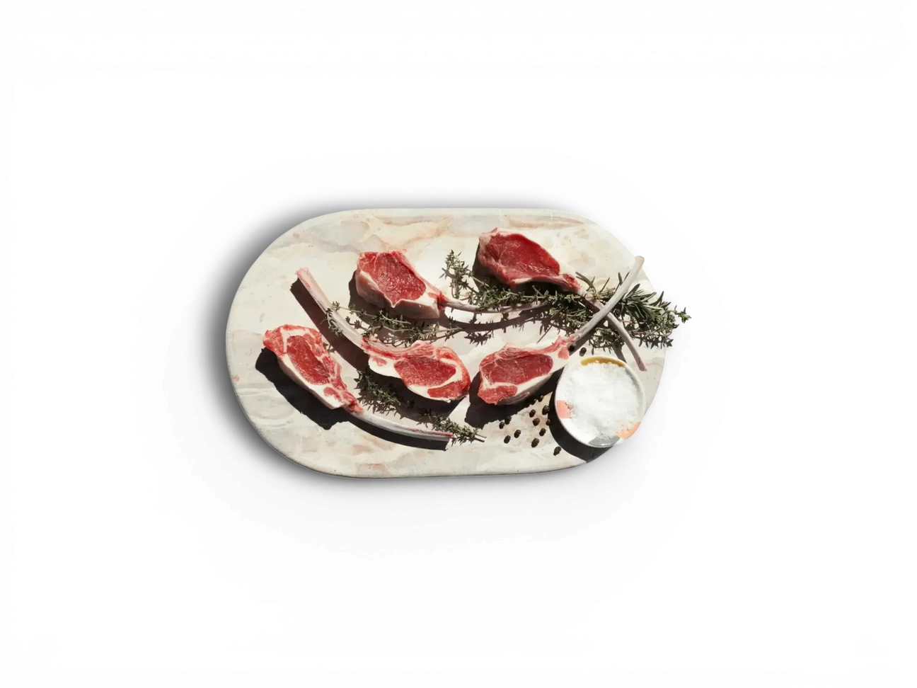 Australian lamb chops on marble board with rosemary and salt from Peter Augustus Craft Butcher