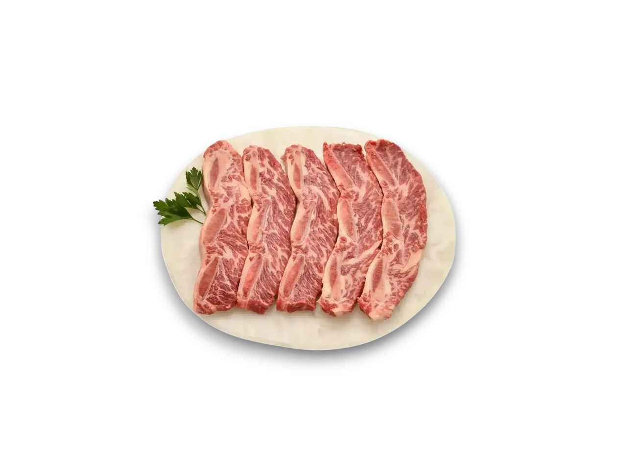 Raw Angus Asado beef ribs with rich marbling arranged on a round plate, garnished with parsley