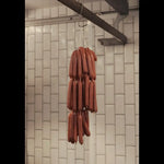 String of handcrafted gourmet sausages hanging in Peter Augustus butcher shop