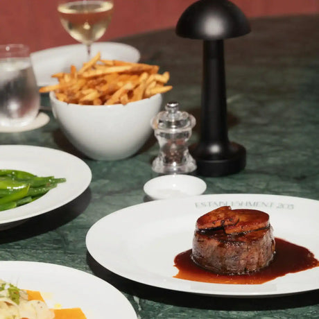 Premium Australian beef filet with sauce, fries, green beans, and wine at Peter Augustus Craft Butcher