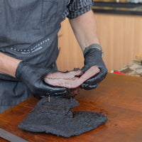 Peter Augustus craft butcher slicing smoked Australian beef brisket