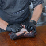 Peter Augustus butcher shredding smoked Australian beef brisket with gloves