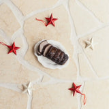 Sliced Australian beef roast on a white plate with red and white star decorations, Peter Augustus