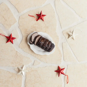 Sliced Australian beef roast on a white plate with red and white star decorations, Peter Augustus