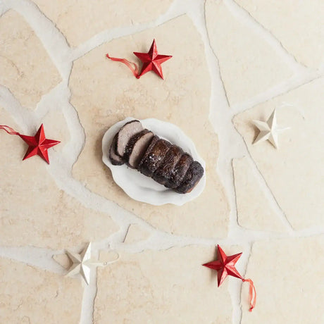 Sliced Australian beef roast on a white plate with red and white star decorations, Peter Augustus