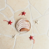 Sliced roast pork on a plate with red and white star decorations, Peter Augustus butcher