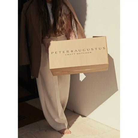 Person holding Peter Augustus Craft Butcher box, Australian beef delivery service.