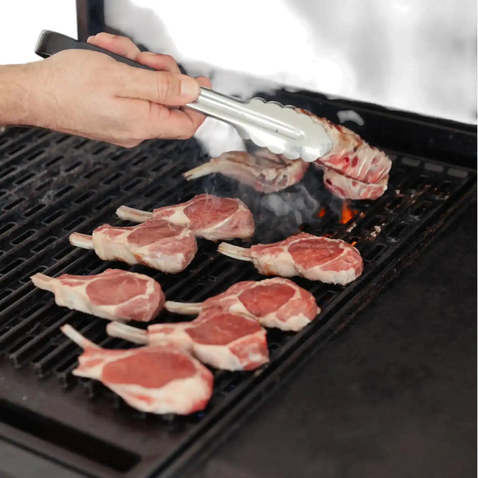 Premium Australian lamb cutlets frenched on a black plate with rosemary and salt, Peter Augustus