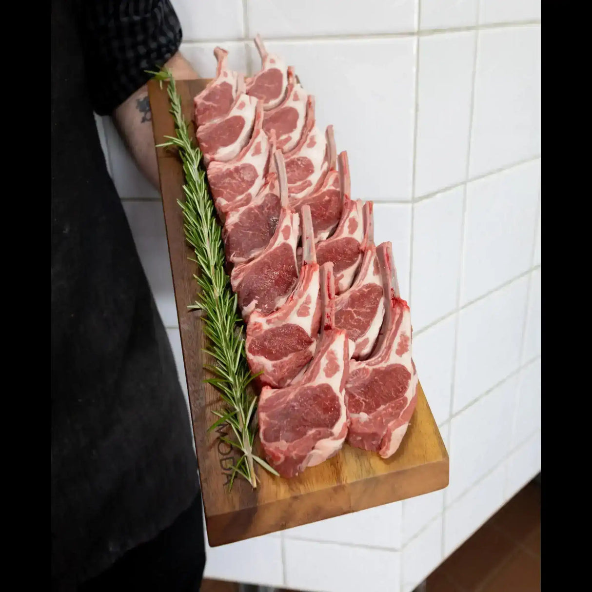 Premium lamb cutlets on wooden board with rosemary, Peter Augustus Craft Butcher selection