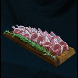 Premium lamb cutlets arranged on a wooden board with rosemary, Peter Augustus Craft Butcher