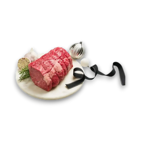 Premium marbled beef roast with rosemary, garlic, and festive ornaments on marble platter