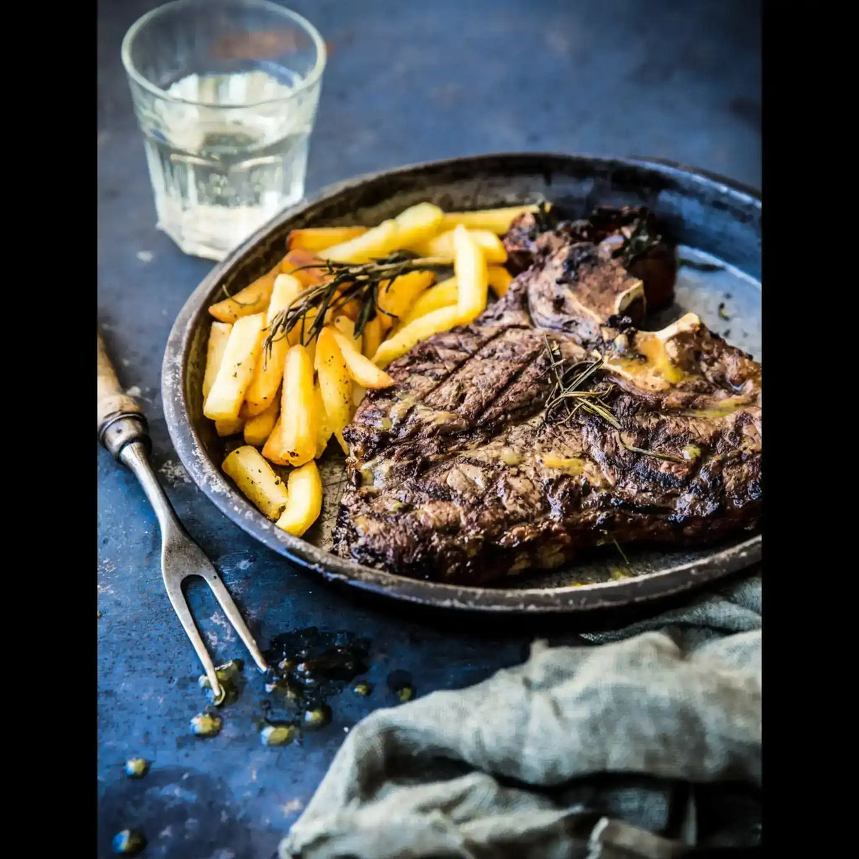 Grilled Australian beef steak with fries and rosemary served on a plate from Peter Augustus