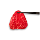 Red marbled steak with a black knife 