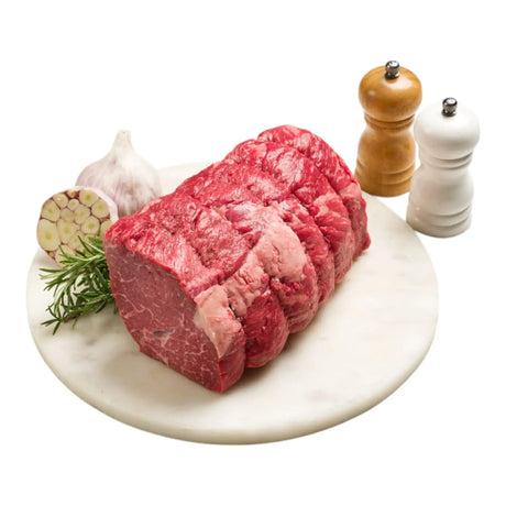 Rost Biff Black Onyx rump roast on marble board with garlic, rosemary, and pepper mills