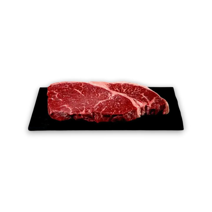 Premium marbled beef steak on black slate, fresh grass-fed Australian beef cut
