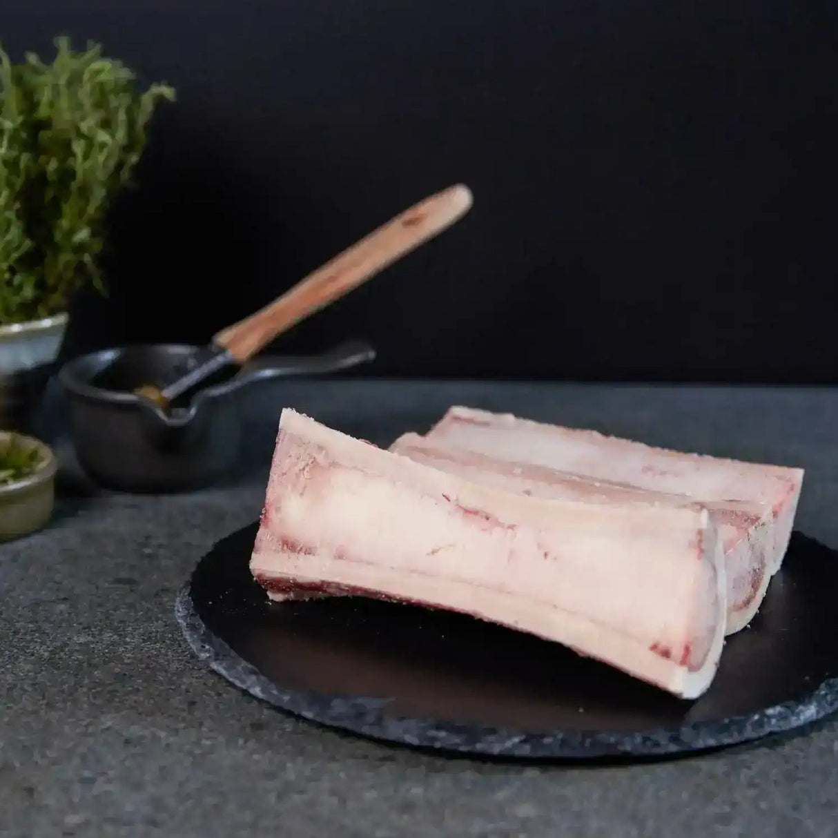Australian beef marrow bones on slate plate with fresh herbs, Peter Augustus Craft Butcher