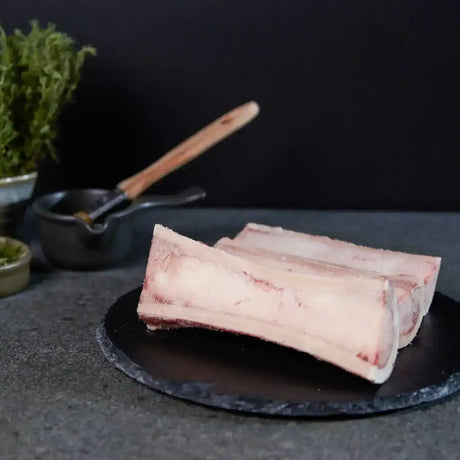 Australian beef marrow bones on slate plate with fresh herbs, Peter Augustus Craft Butcher