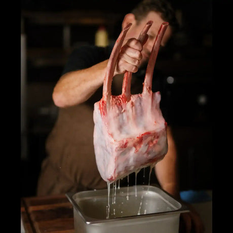 Butcher holding premium Australian beef rib rack above tray, Peter Augustus Craft Butcher