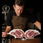 Craft butcher displaying premium marbled Australian beef ribeye at Peter Augustus