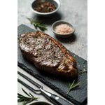 Grilled Diamantina Angus striploin steak with rosemary, sea salt, and pepper, premium Australian beef