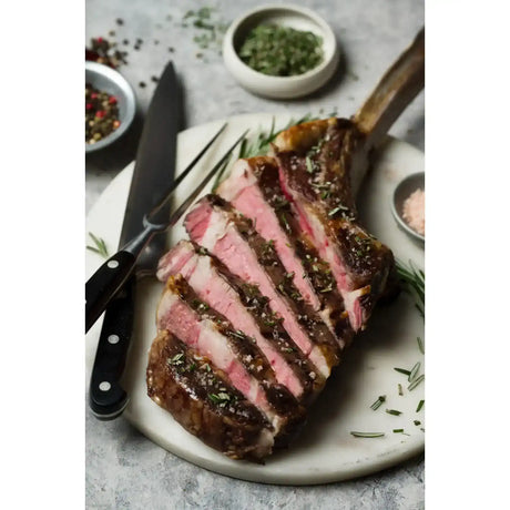Sliced Diamantina Angus Tomahawk steak with herbs, premium Australian beef by Peter Augustus