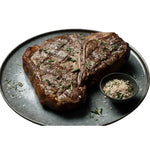 Grilled Diamantina Angus T-bone steak with sea salt and herbs on a plate from Peter Augustus