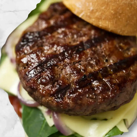 Juicy Diamantina Wagyu burger with grill marks, melted cheese, spinach, and artisan bun