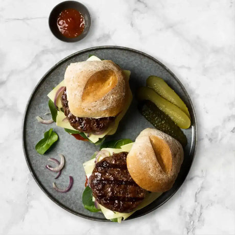 Diamantina Wagyu beef burgers on artisan rolls with cheese, pickles, spinach, and sauce
