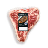 Vacuum-sealed Diamantina Angus T-bone steak with visible marbling on white background
