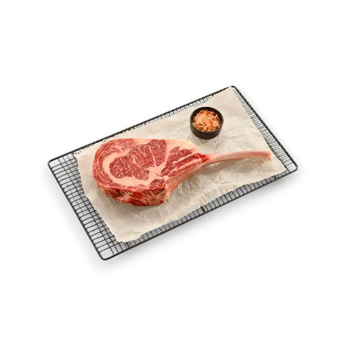 Marbled Wagyu tomahawk steak on wire rack with pink salt, fresh grass-fed beef cut