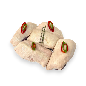 Raw duck breasts with red and green pepper slices on a transparent background